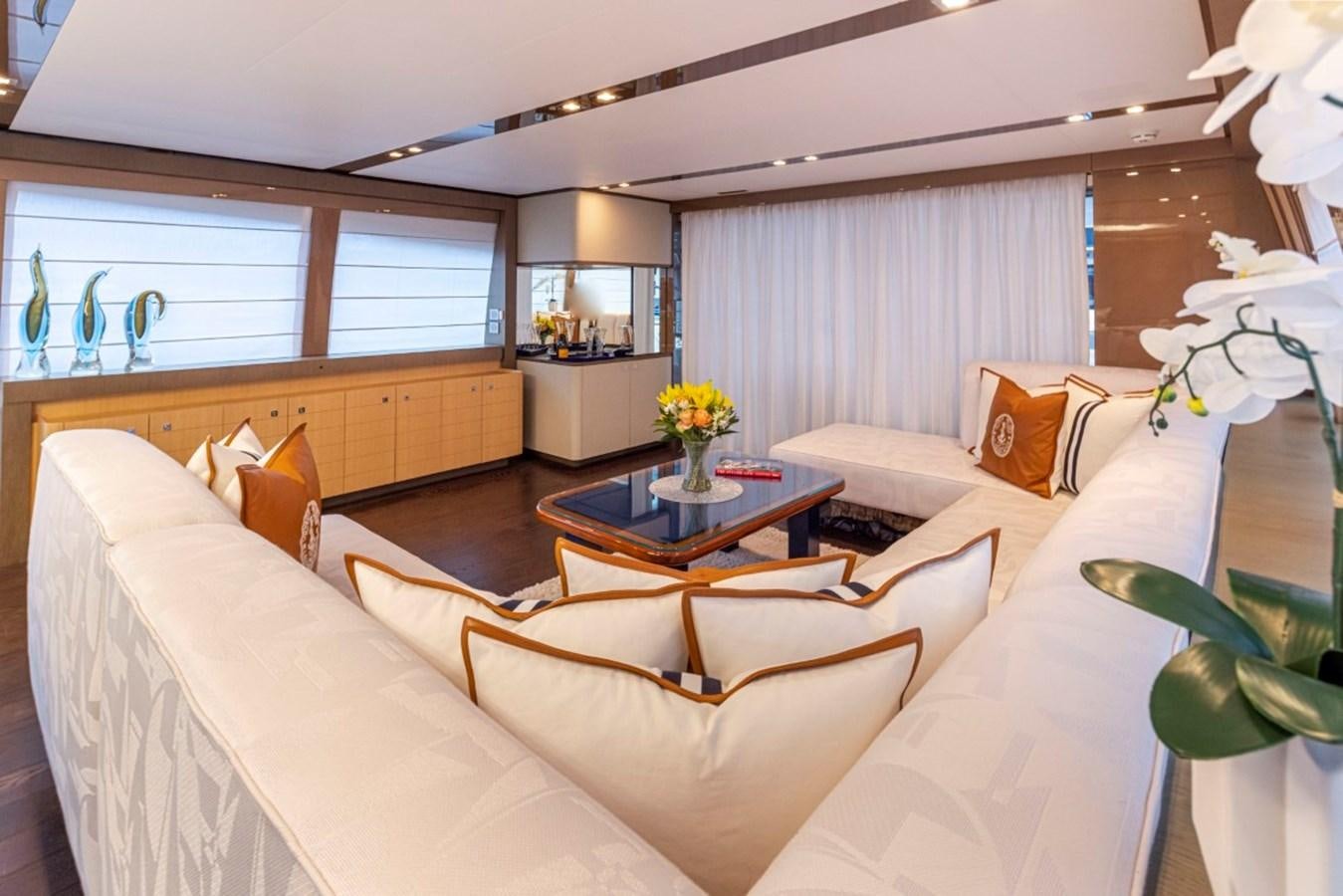 a living room with white couches aboard SOL SHINE Yacht for Sale