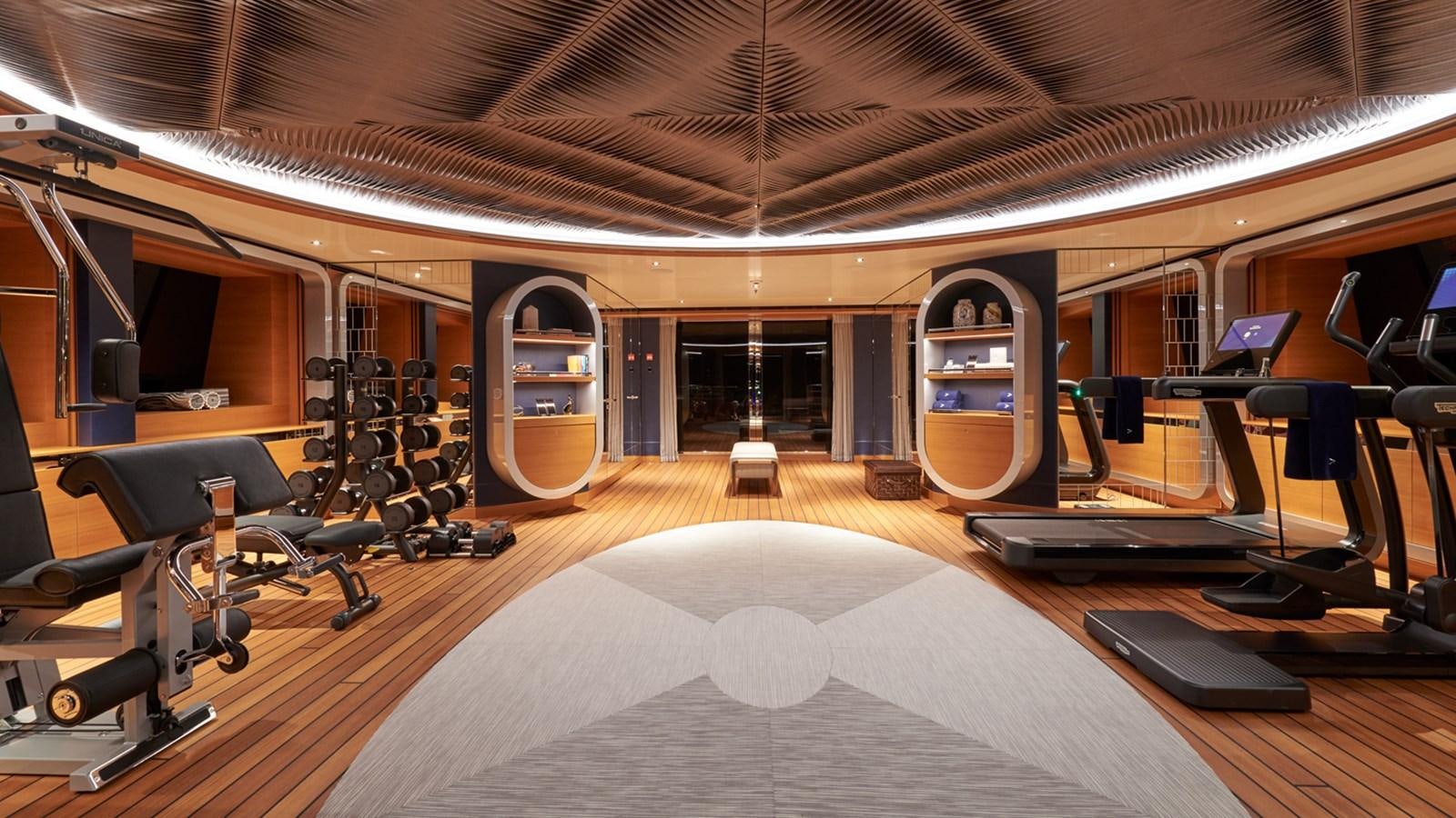 a gym with a large mirror aboard ARROW Yacht for Charter