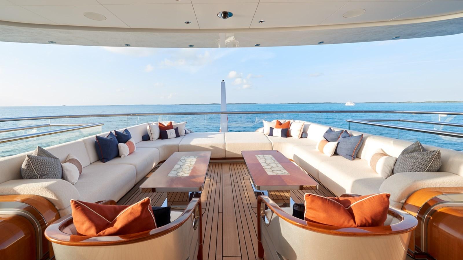 a deck with a large body of water and a deck with chairs aboard ARROW Yacht for Sale