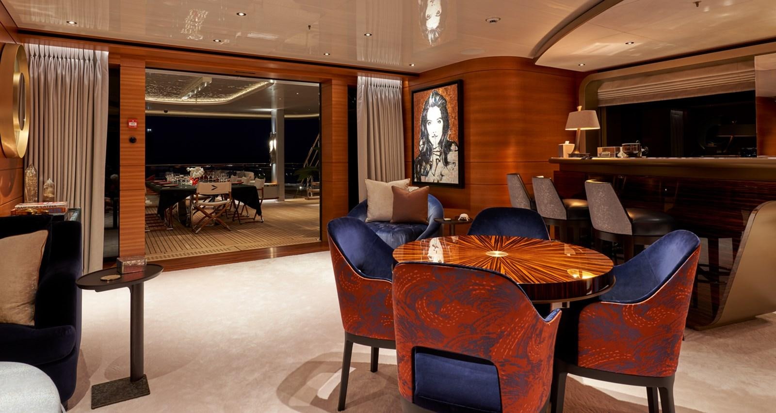a room with a table chairs and a couch aboard ARROW Yacht for Charter