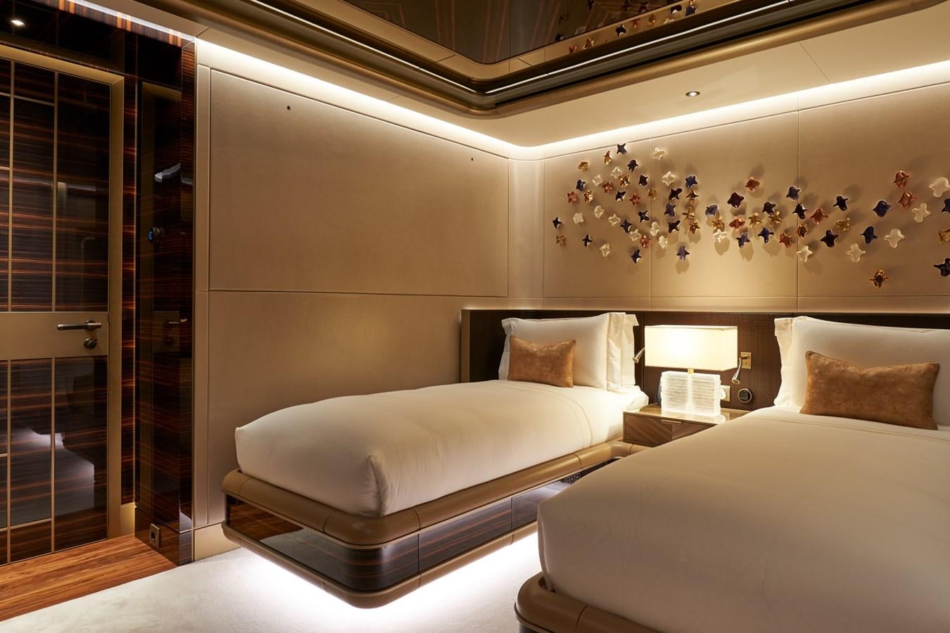 a couple of beds in a hotel room aboard ARROW Yacht for Charter