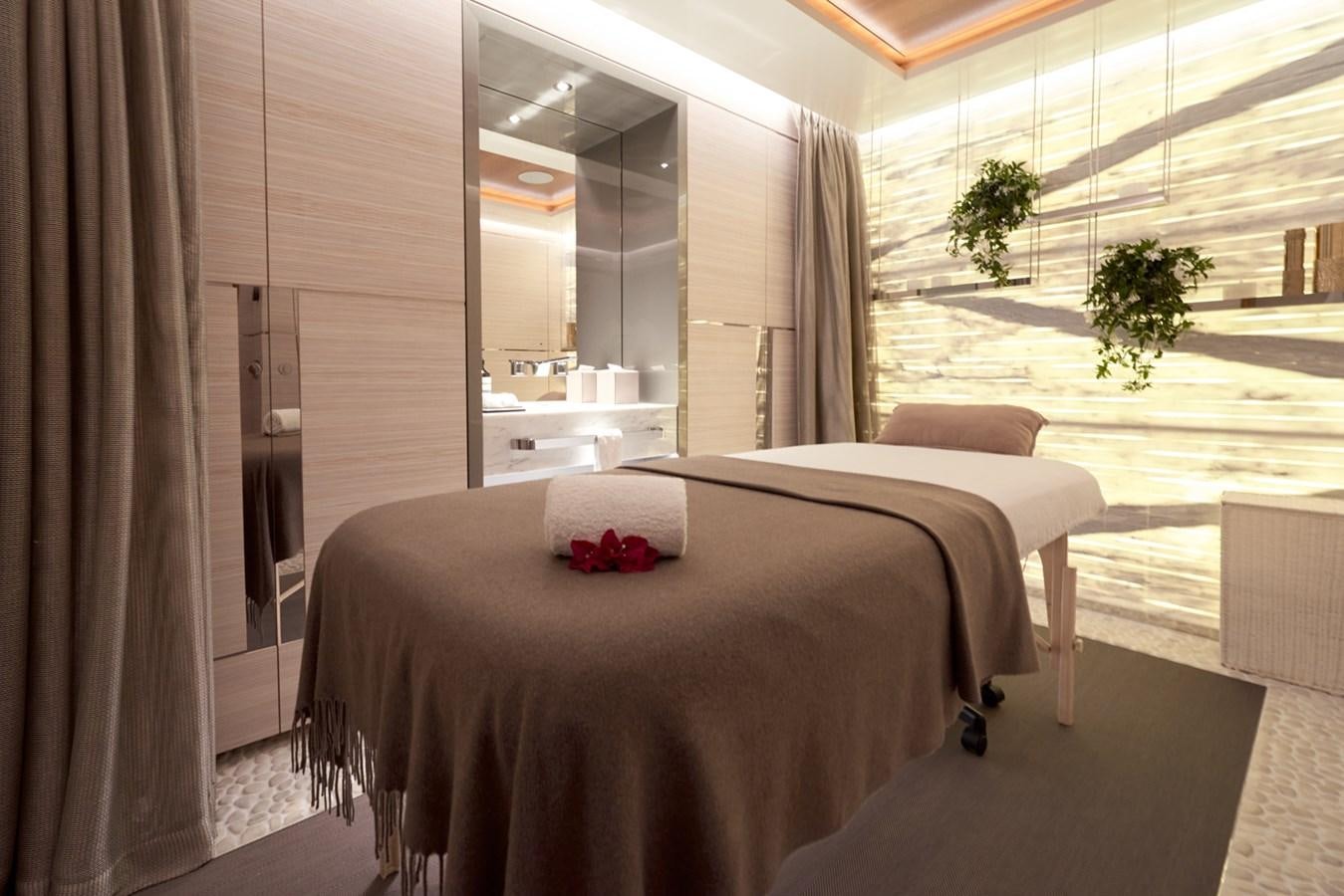 a room with a bed and a mirror aboard ARROW Yacht for Charter