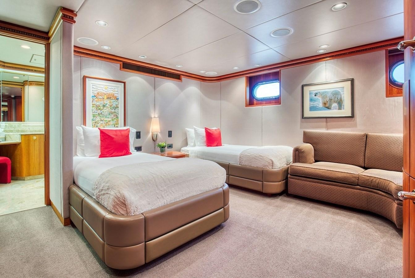 a room with a bed and a couch aboard ICE BEAR Yacht for Sale