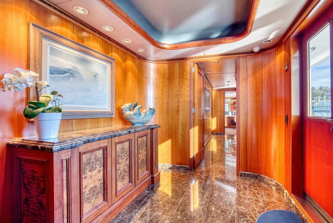 a room with a large mirror and a wood cabinet aboard ICE BEAR Yacht for Sale