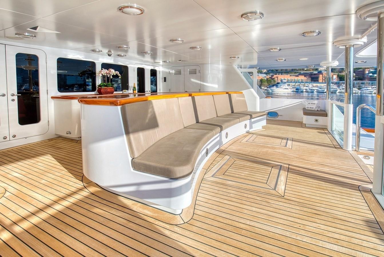 a room with a couch and a tv on the wall aboard ICE BEAR Yacht for Sale