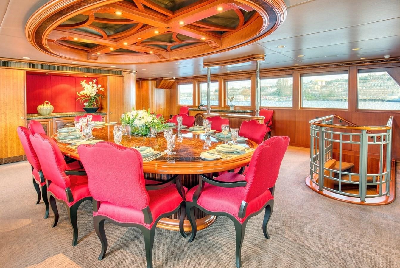 a dining room with red chairs aboard ICE BEAR Yacht for Sale