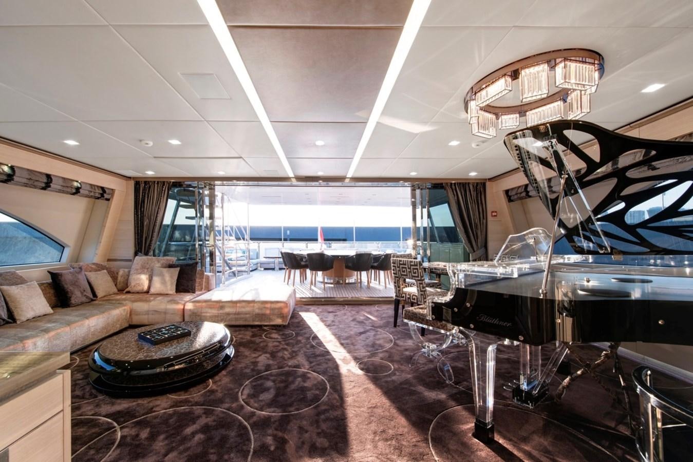 a living room with a large sofa and a large window aboard CHARADE Yacht for Sale