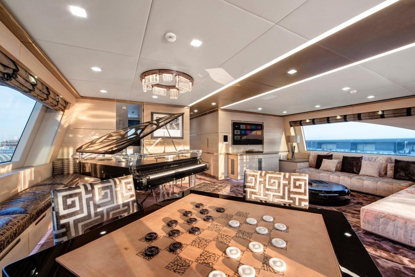 a room with a table and couches aboard CHARADE Yacht for Sale