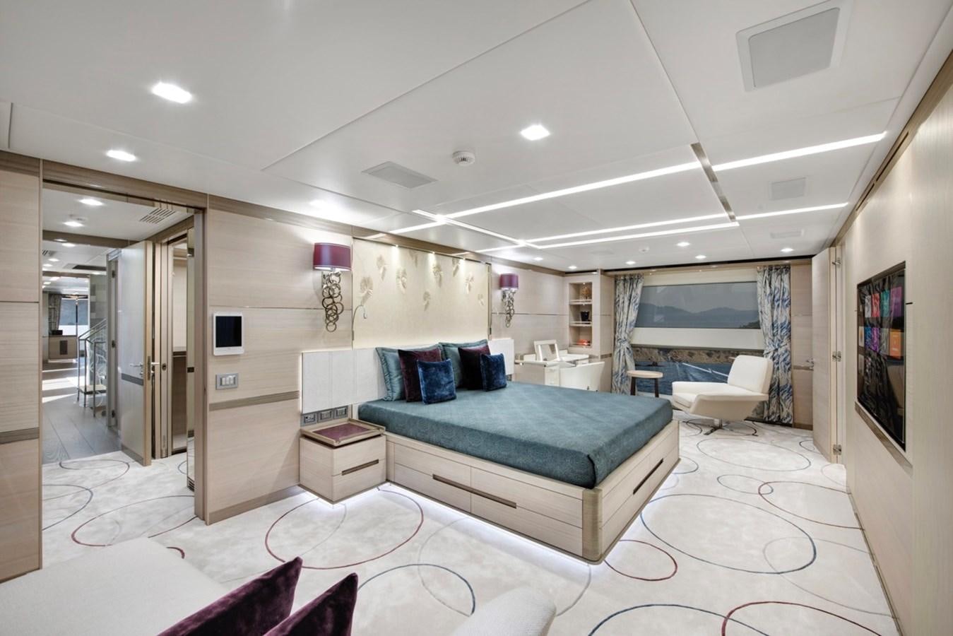 a bedroom with a bed and a desk aboard CHARADE Yacht for Sale