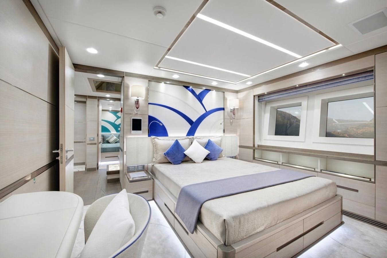 a bedroom with a bed and a chair aboard CHARADE Yacht for Sale