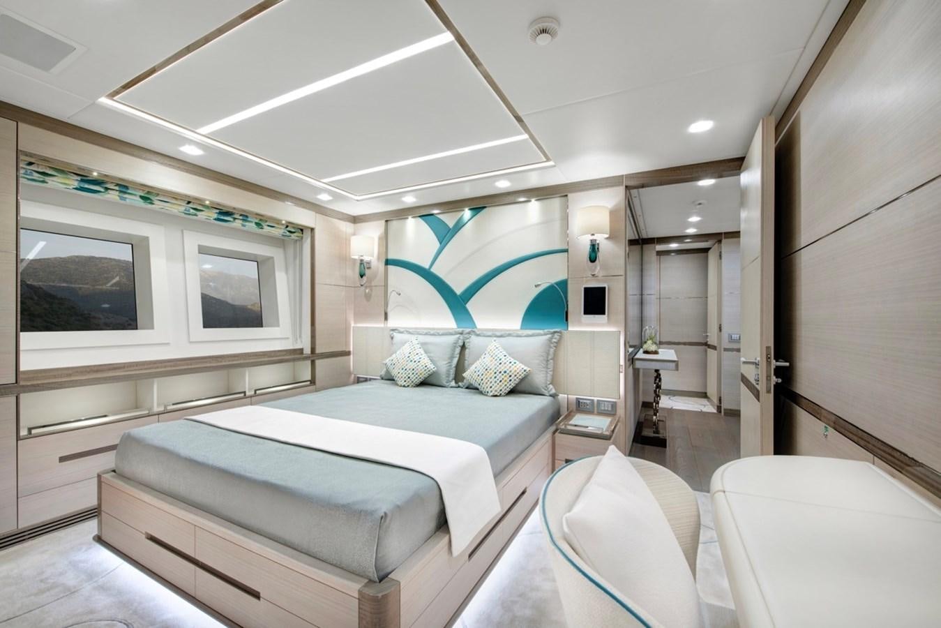 a bedroom with a bed and a chair aboard CHARADE Yacht for Sale