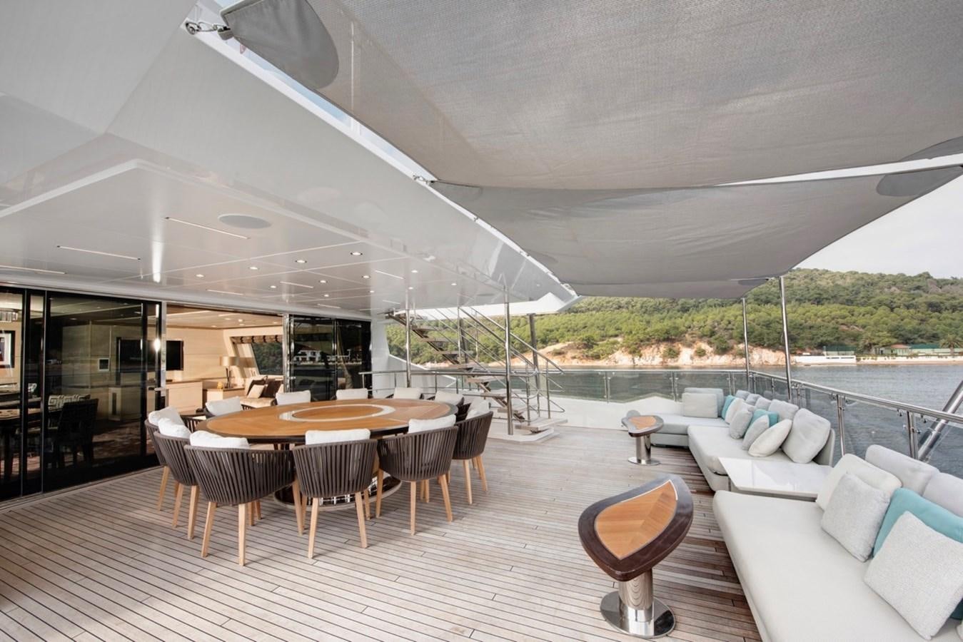 a large lounge area with a table and chairs on it aboard CHARADE Yacht for Sale