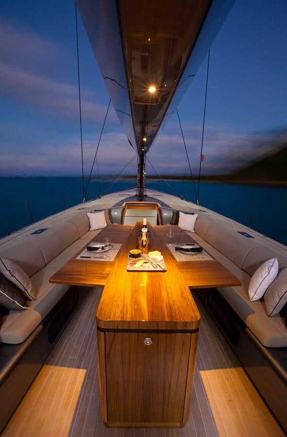 a room with a table and a bed aboard AEGIR Yacht for Sale