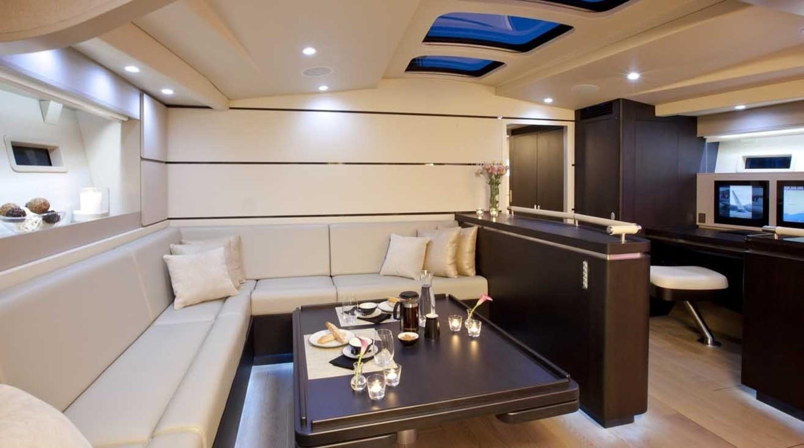 a living room with a white couch and a coffee table aboard AEGIR Yacht for Sale