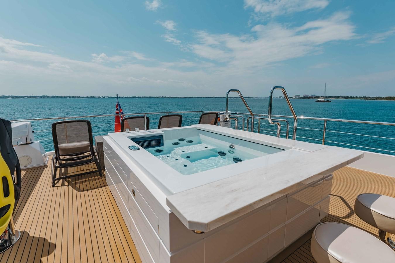 a large white pool on a deck overlooking the ocean aboard MIDNIGHT MOON Yacht for Sale