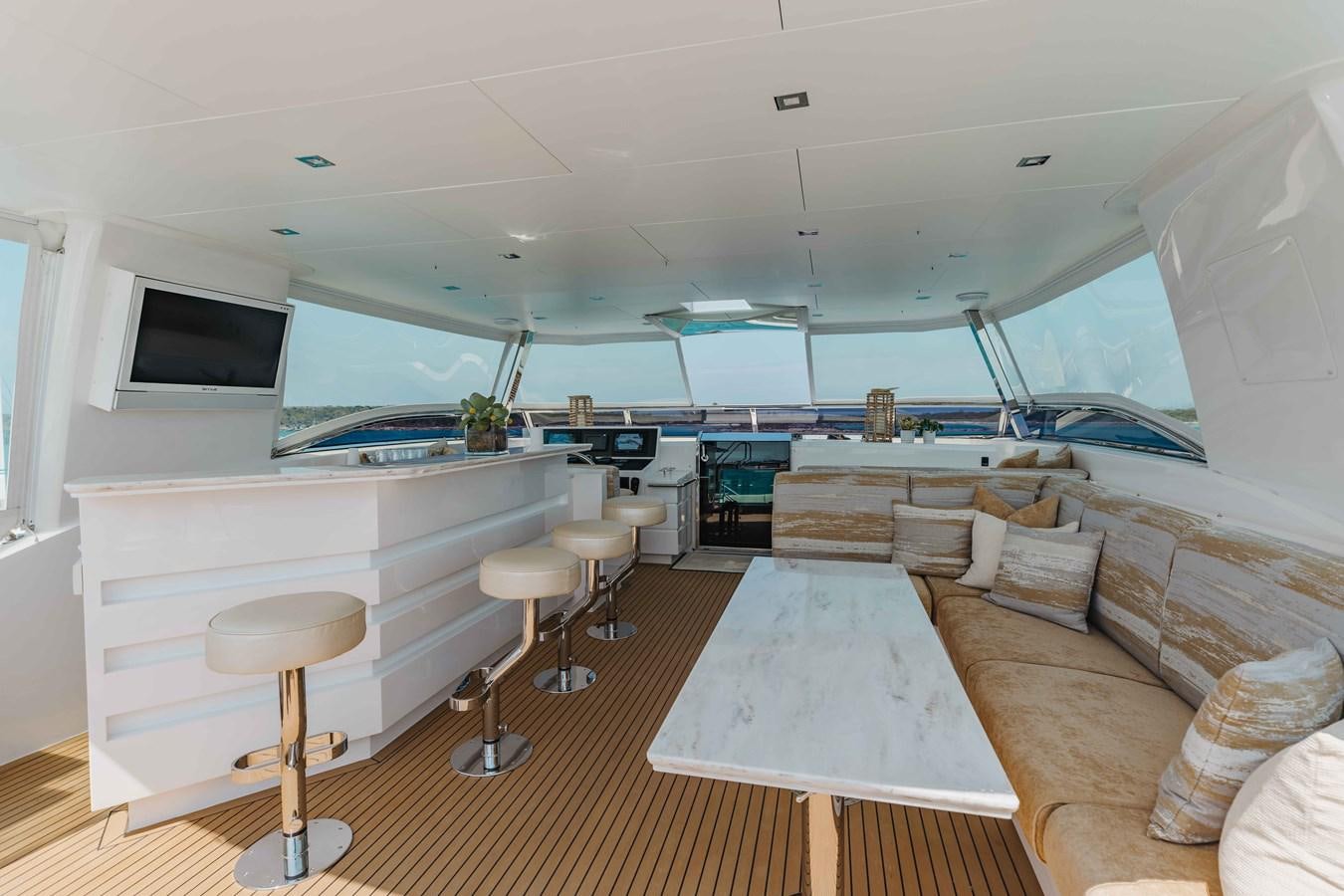 a room with a couch and a table and chairs aboard MIDNIGHT MOON Yacht for Sale