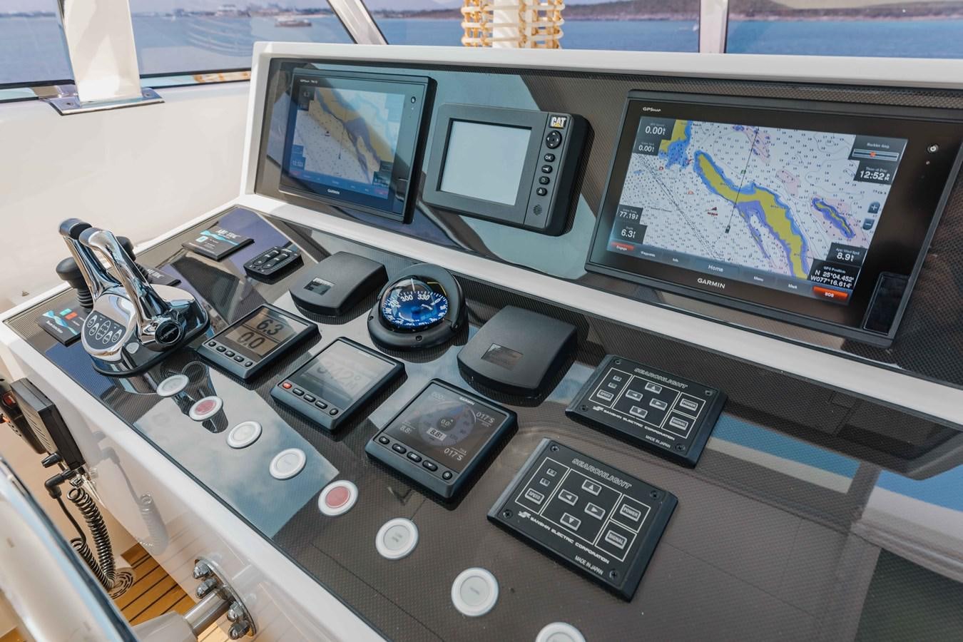 a desk with a computer and other electronics on it aboard MIDNIGHT MOON Yacht for Sale