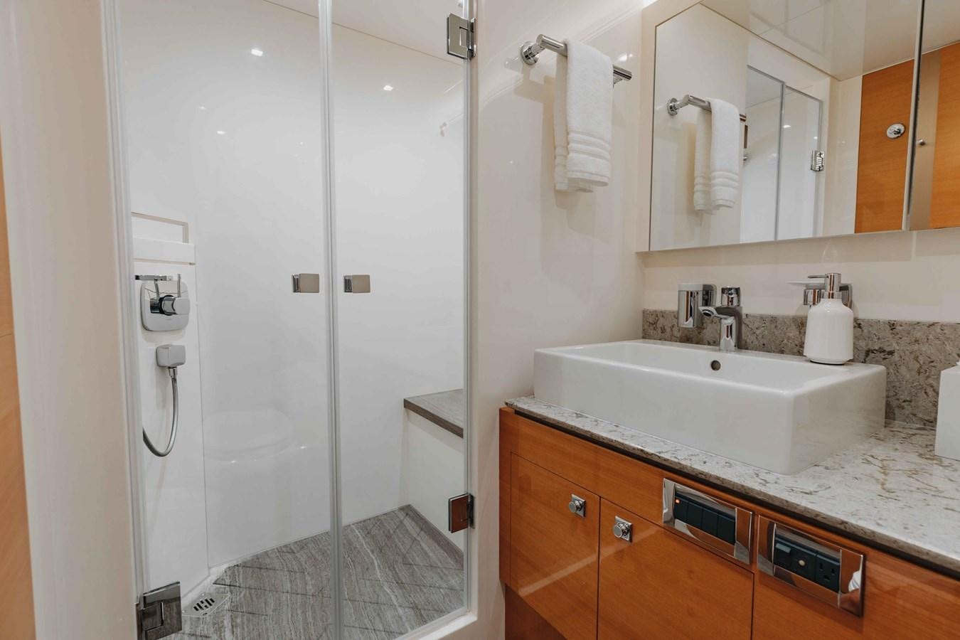 a bathroom with a shower unit and sink aboard MIDNIGHT MOON Yacht for Sale