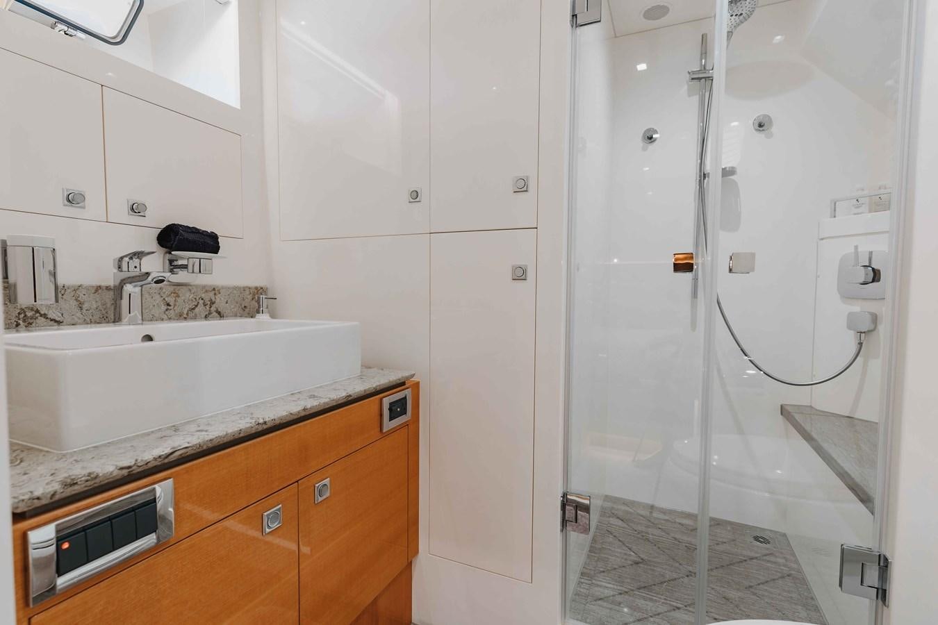 a bathroom with a shower unit and sink aboard MIDNIGHT MOON Yacht for Sale
