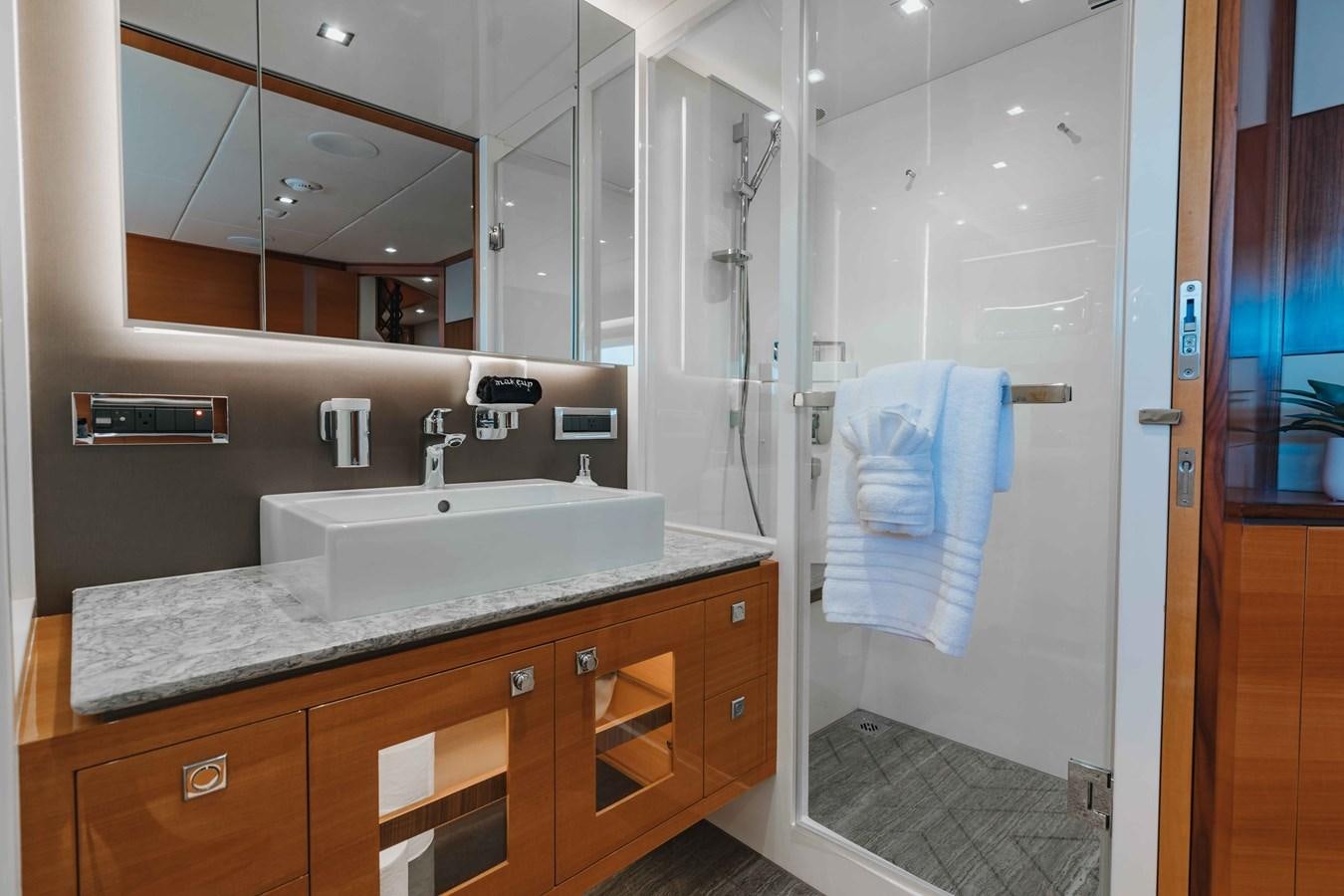a bathroom with a sink and a shower unit aboard MIDNIGHT MOON Yacht for Sale