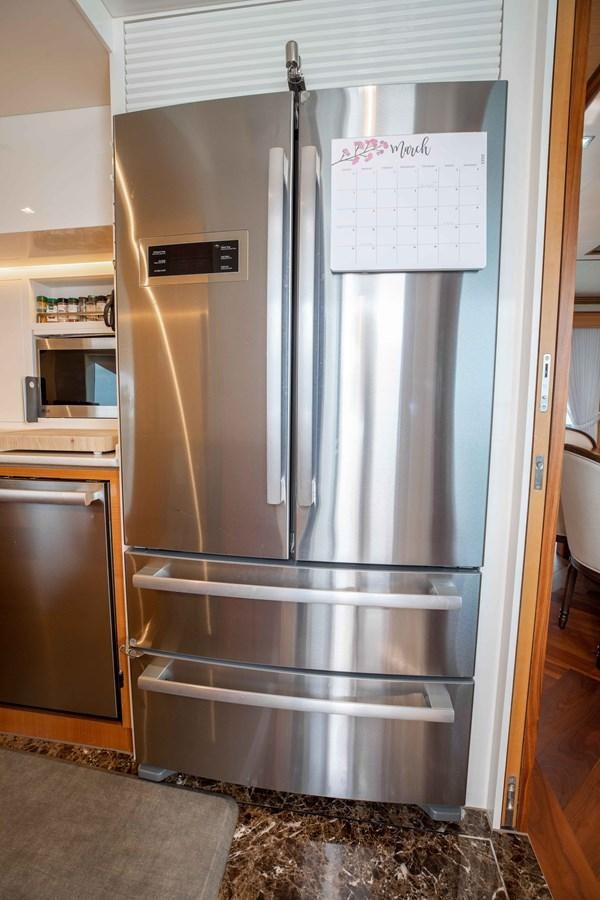 a refrigerator is in a kitchen aboard MIDNIGHT MOON Yacht for Sale