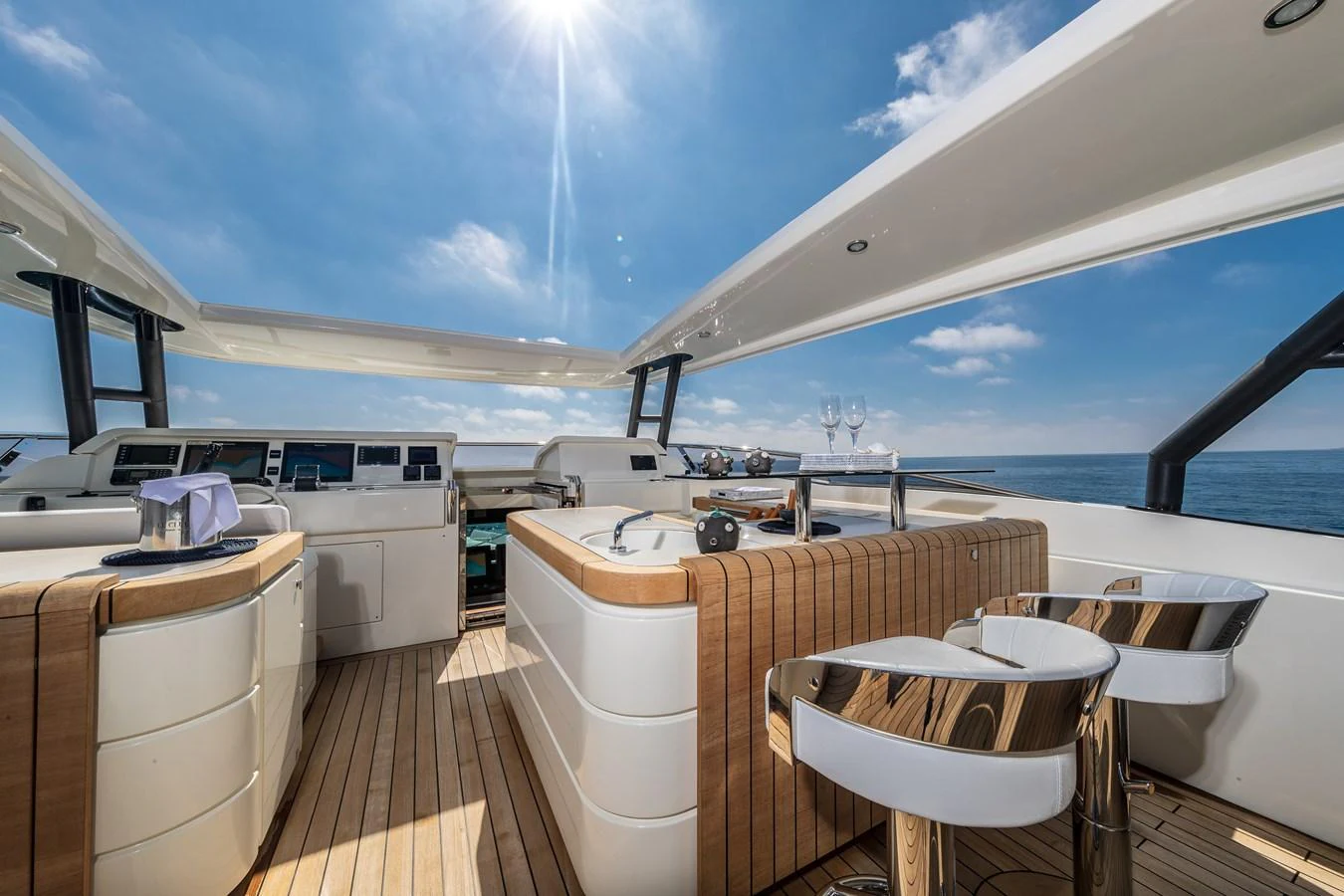 a large open space with a table and chairs and a large body of water aboard LADY MARISA Yacht for Sale
