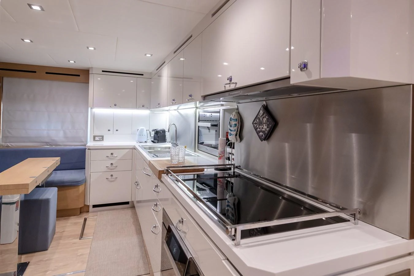 a kitchen with white cabinets aboard LADY MARISA Yacht for Sale