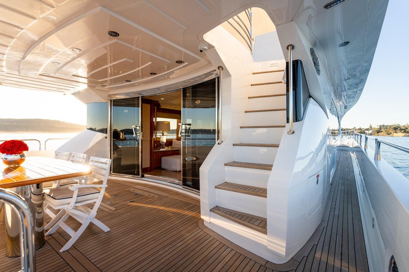 a white boat on a deck aboard CHAOS Yacht for Sale