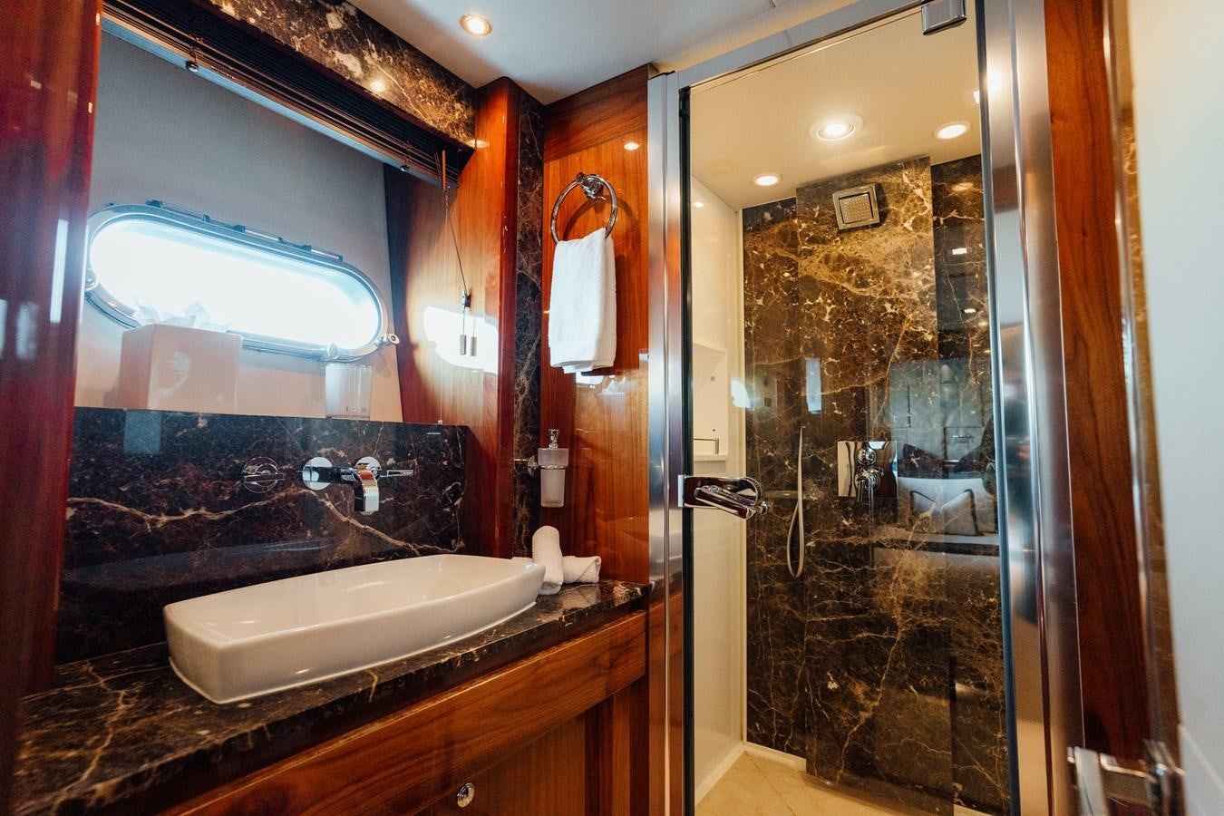 a bathroom with a large mirror aboard CHAOS Yacht for Sale