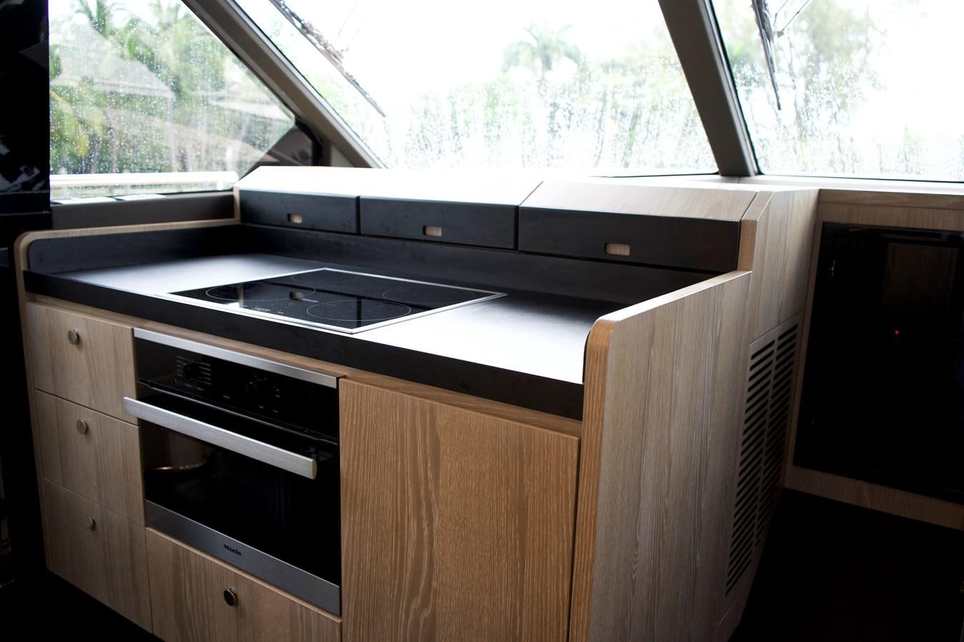 a kitchen with a stove and cabinets aboard RAINBOW GODDESS Yacht for Sale