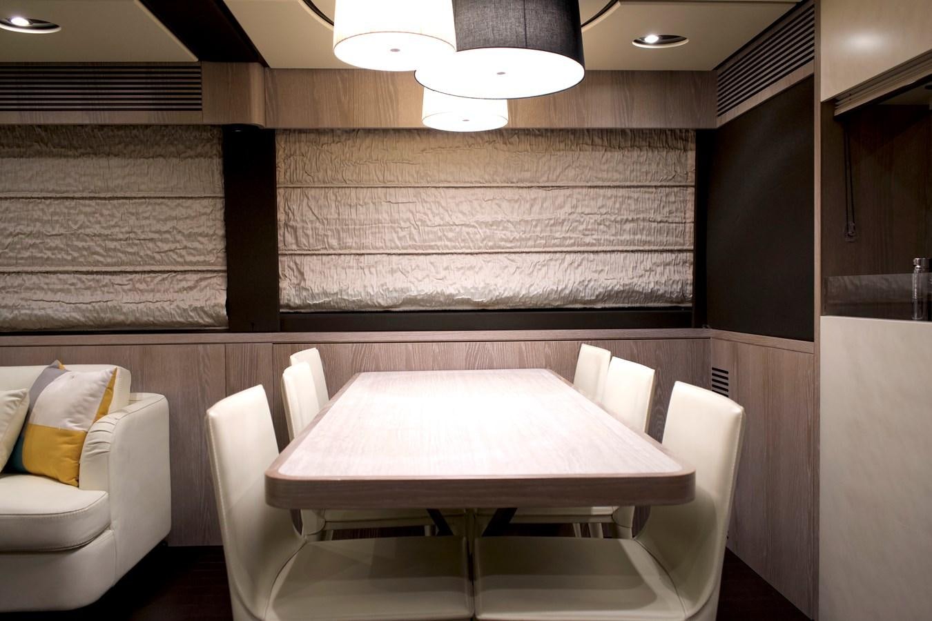 a room with a table and chairs aboard RAINBOW GODDESS Yacht for Sale