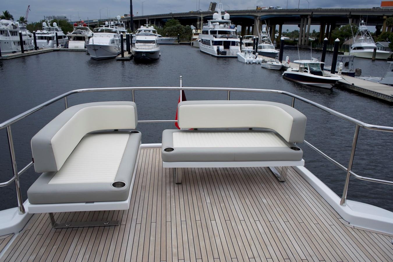 a white lounge chair on a dock aboard RAINBOW GODDESS Yacht for Sale