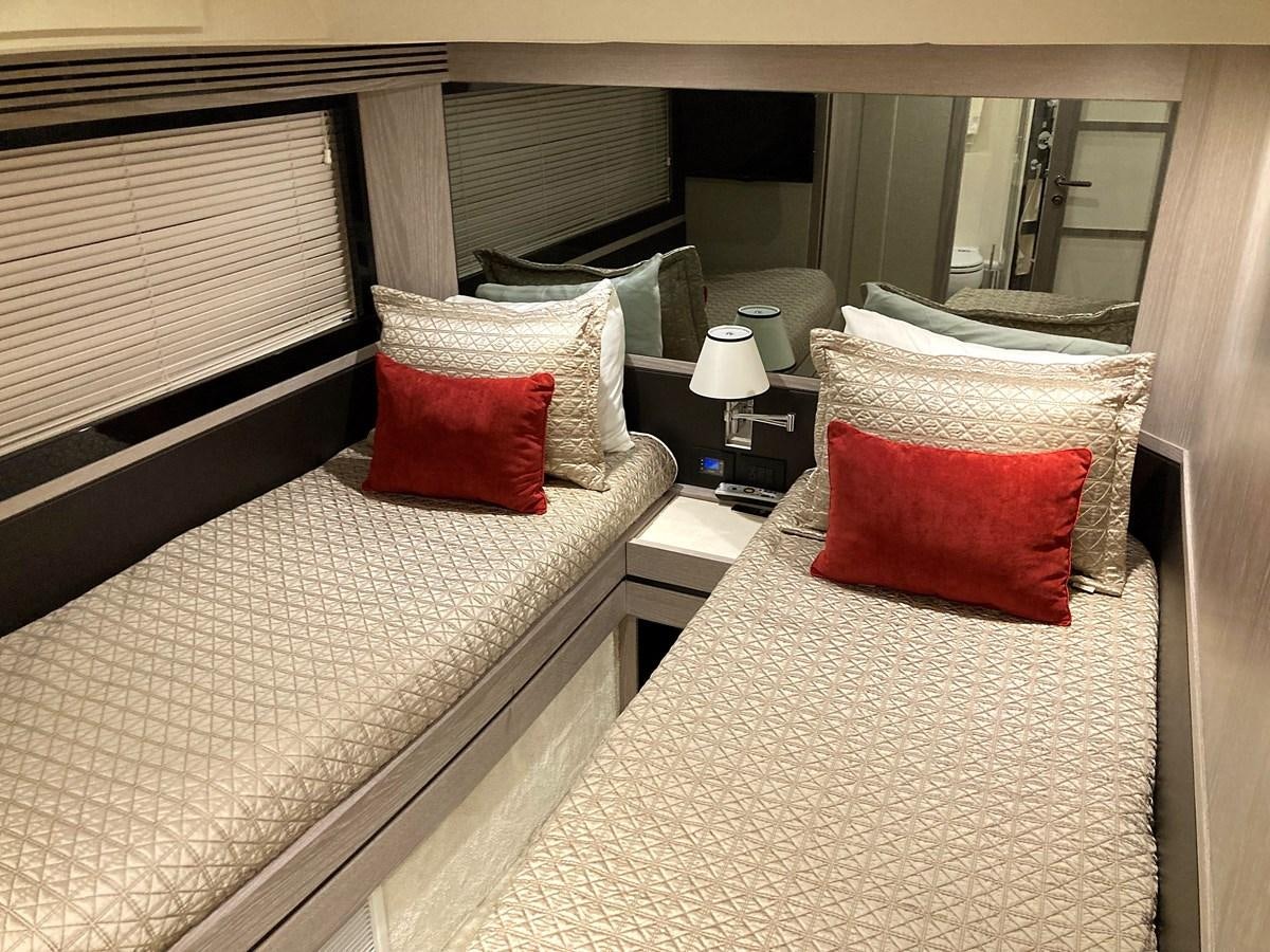 a bed with pillows and a mirror aboard RAINBOW GODDESS Yacht for Sale