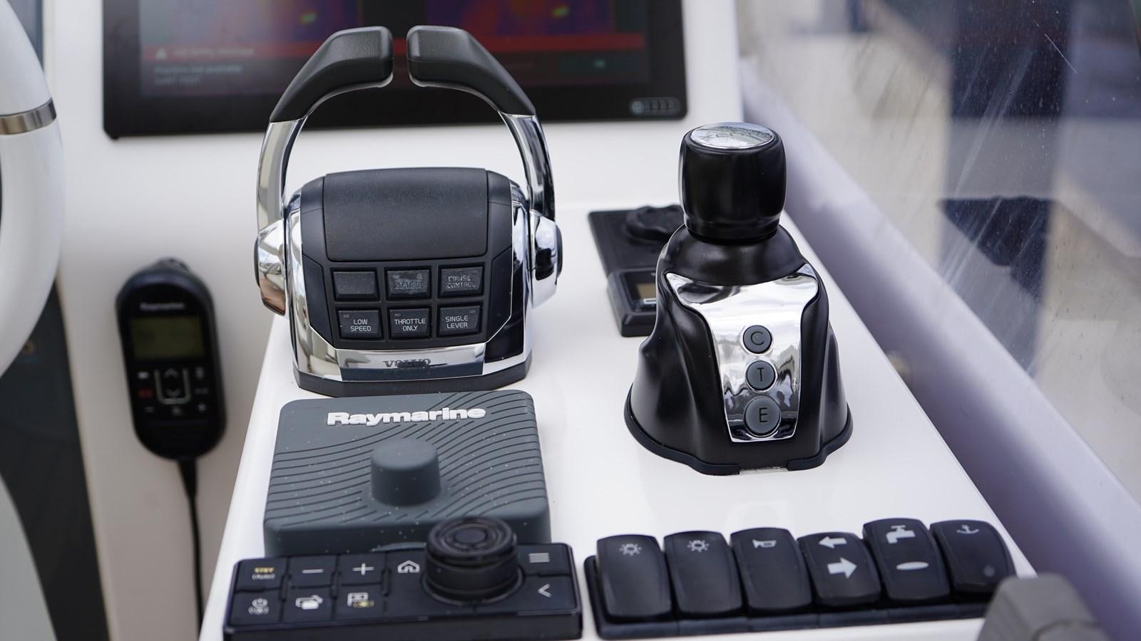 a group of cell phones and a camera on a table aboard RAINBOW GODDESS Yacht for Sale