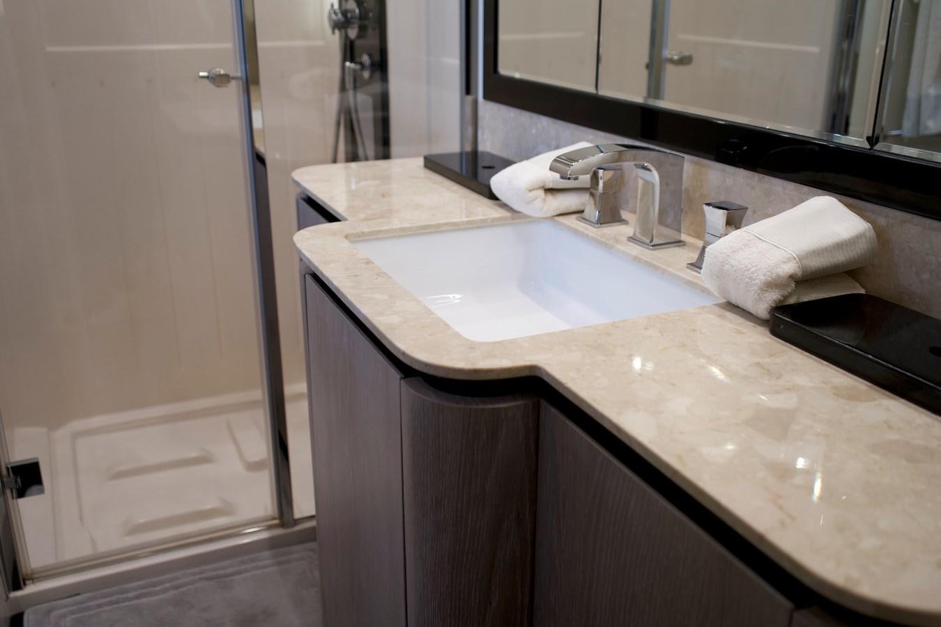 a bathroom with a sink and a mirror aboard RAINBOW GODDESS Yacht for Sale