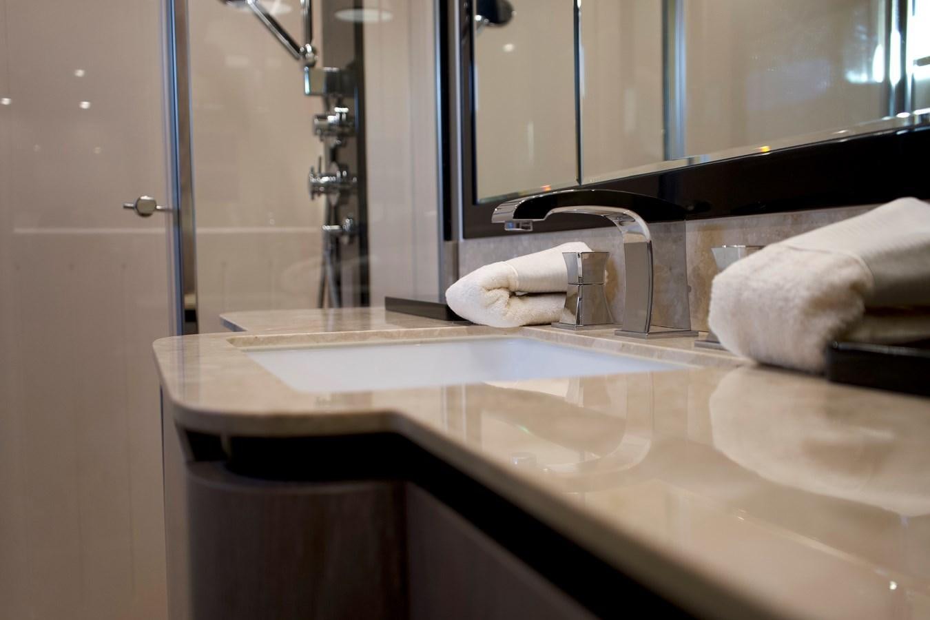 a bathroom sink with towels aboard RAINBOW GODDESS Yacht for Sale