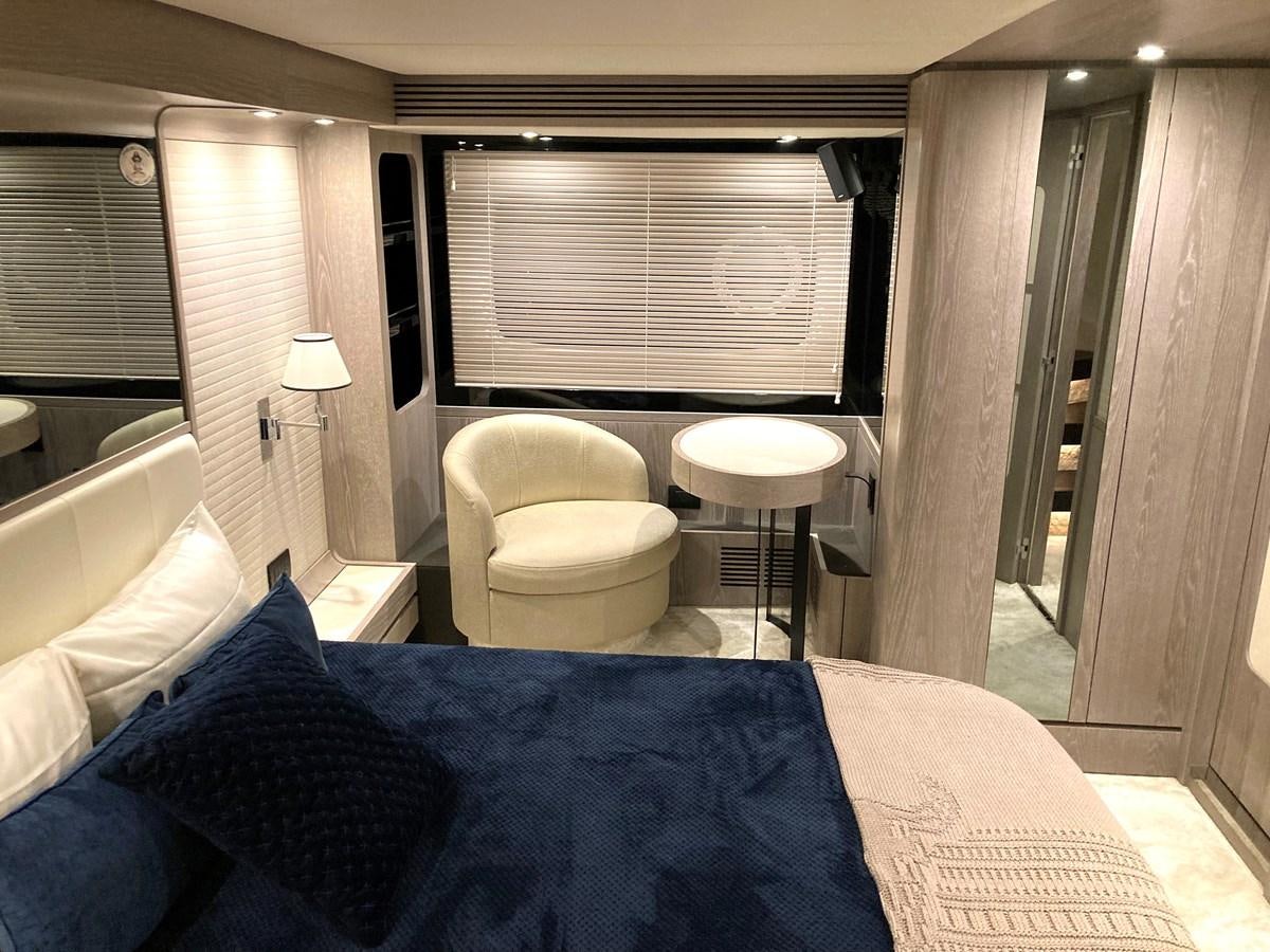 a bed with a blue blanket aboard RAINBOW GODDESS Yacht for Sale