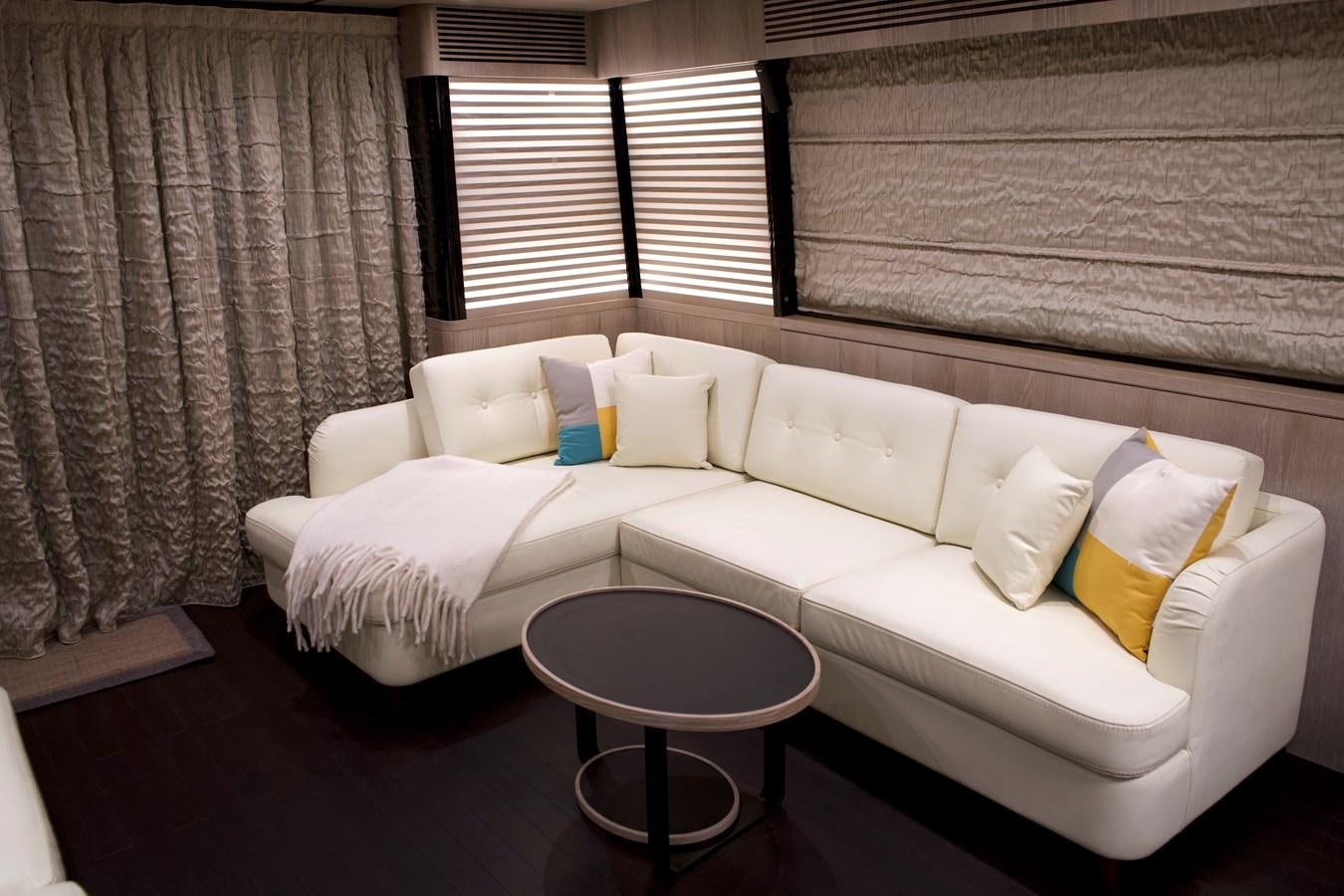 a couch with pillows on it aboard RAINBOW GODDESS Yacht for Sale