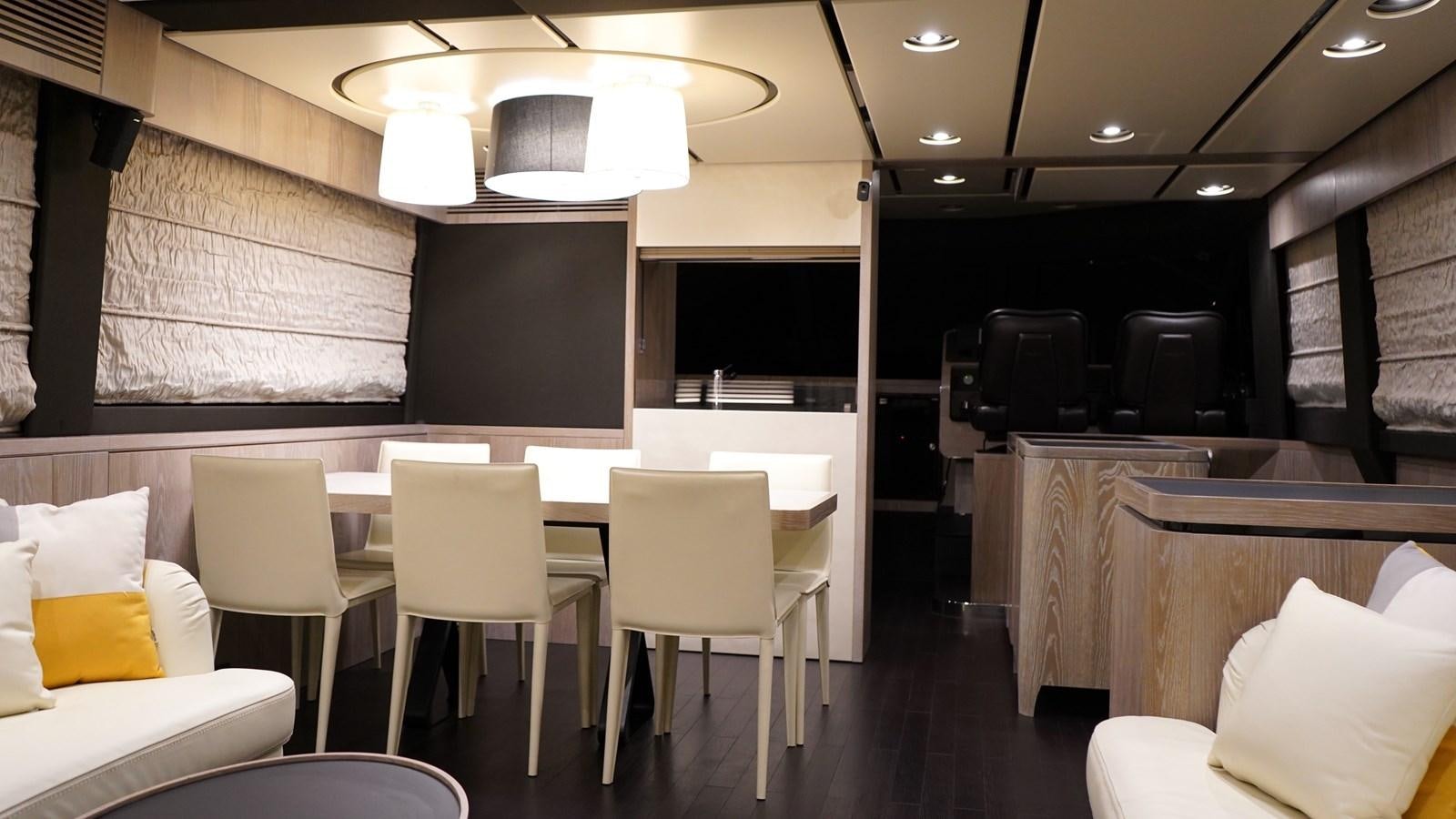 a room with chairs and tables aboard RAINBOW GODDESS Yacht for Sale