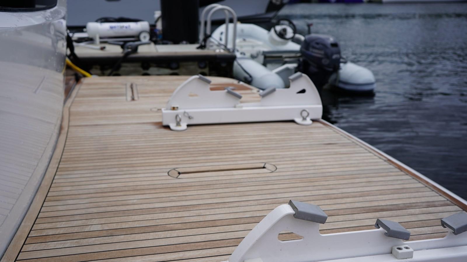 a white boat on a deck aboard RAINBOW GODDESS Yacht for Sale