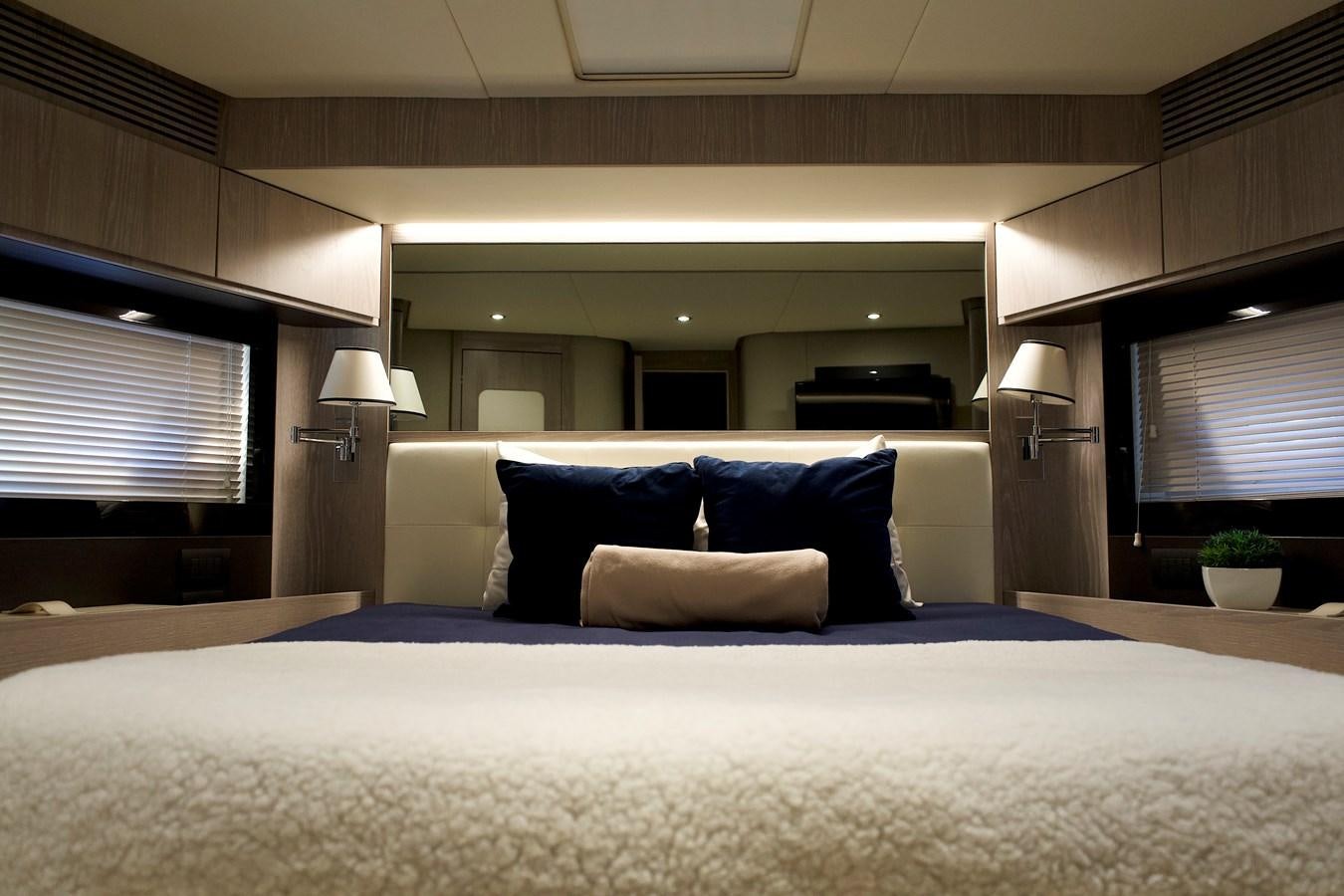 a bed with a white comforter aboard RAINBOW GODDESS Yacht for Sale