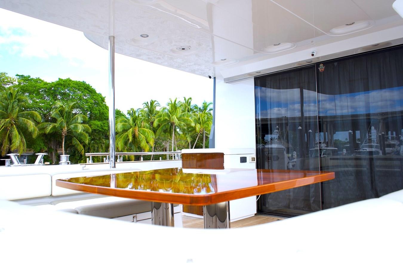 a large glass building with a pool table and trees aboard RAINBOW GODDESS Yacht for Sale