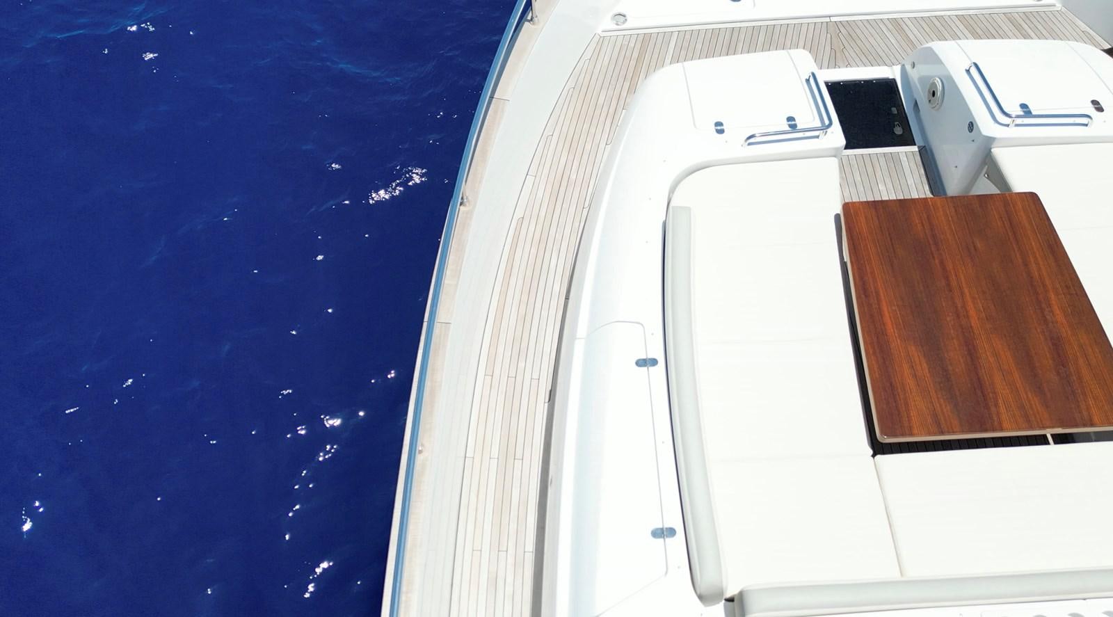 a white smartphone on a blue surface aboard RAINBOW GODDESS Yacht for Sale