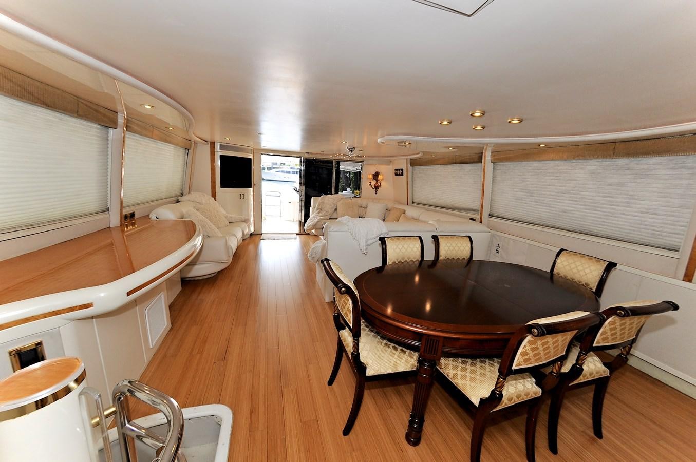 a large room with a table and chairs aboard CAMY Yacht for Sale
