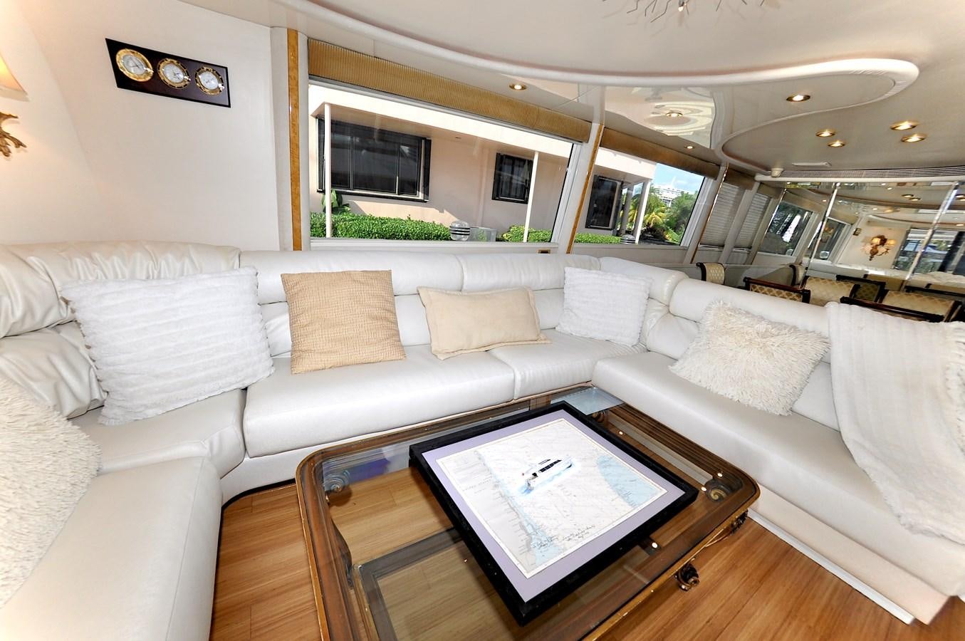 a living room with a couch and a coffee table aboard CAMY Yacht for Sale
