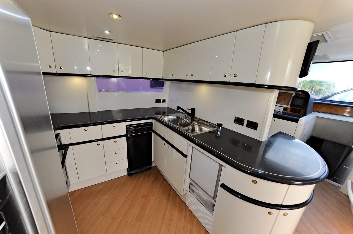 a kitchen with white cabinets aboard CAMY Yacht for Sale