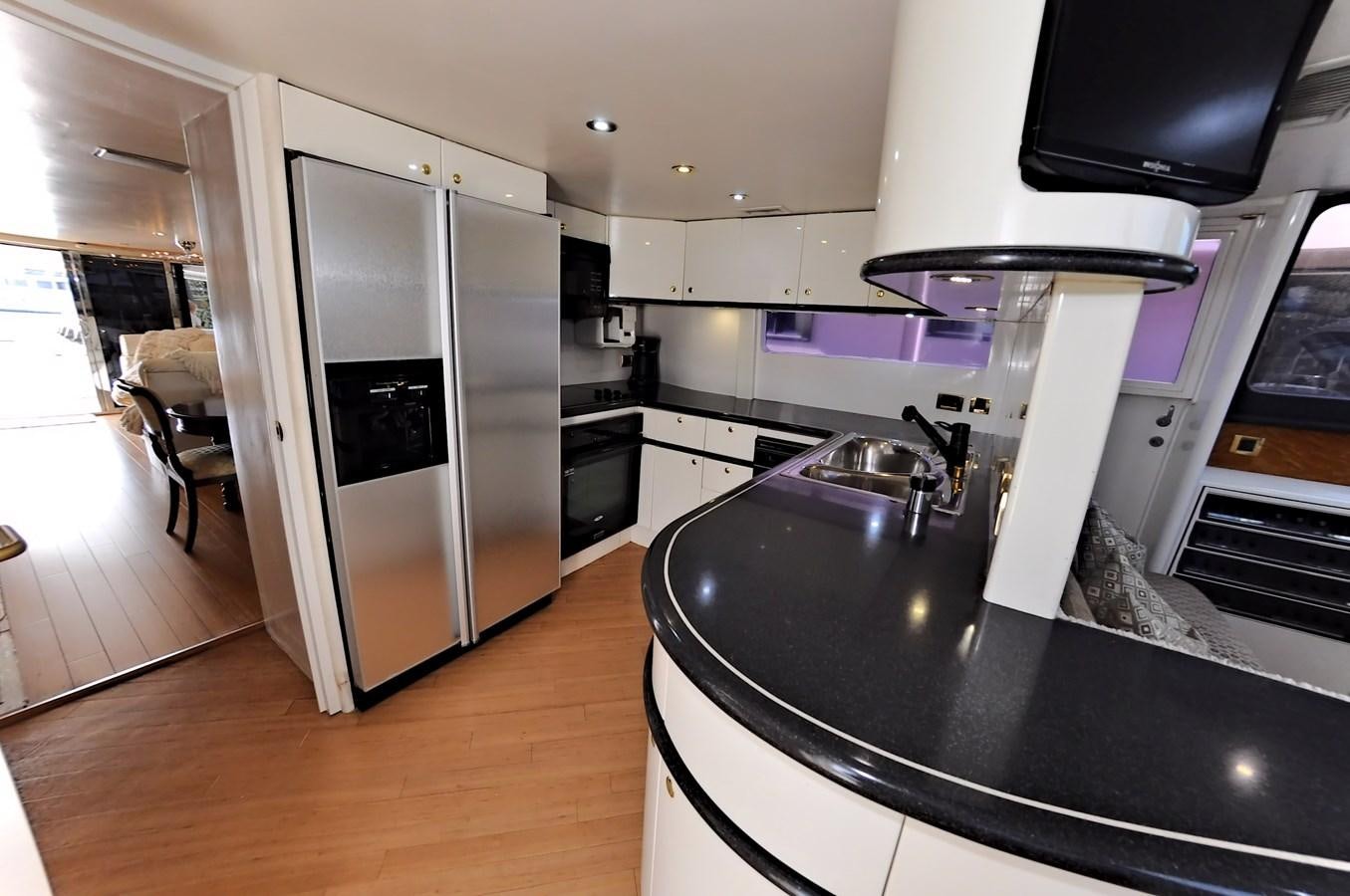 a kitchen with a large refrigerator aboard CAMY Yacht for Sale