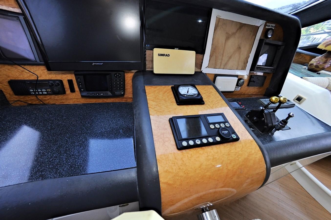 a table with a couple of electronic devices on it aboard CAMY Yacht for Sale