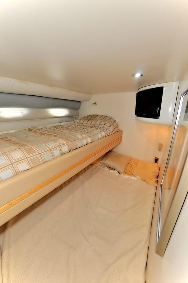 a small television on a bed aboard CAMY Yacht for Sale