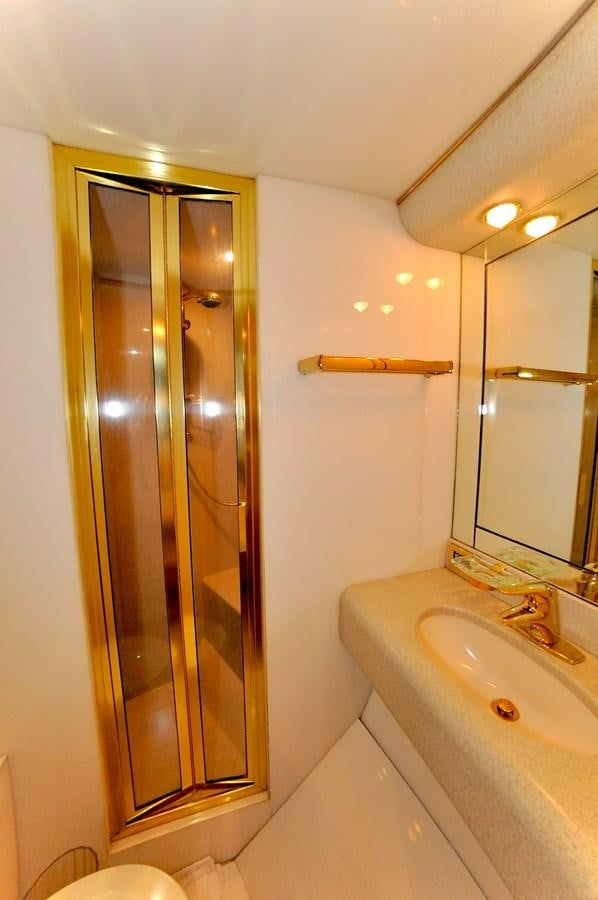 a bathroom with a glass shower door aboard CAMY Yacht for Sale